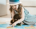 Little girl with her toy studying map, going on vacation with parents. Royalty Free Stock Photo