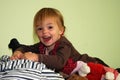 Little girl lies in the middle of all her stuffed animals Royalty Free Stock Photo