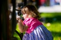 Little girl hiding behind a bench in the park Royalty Free Stock Photo