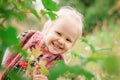 Little girl hiding behind the foliage Royalty Free Stock Photo