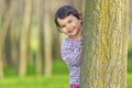 Little girl hiding behind a tree Royalty Free Stock Photo