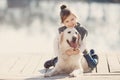 Little girl with his beloved dog at the lake Royalty Free Stock Photo