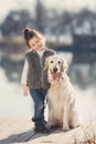 Little girl with his beloved dog at the lake Royalty Free Stock Photo