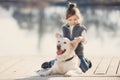 Little girl with his beloved dog at the lake Royalty Free Stock Photo