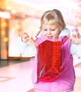 Little girl holding a bag of shopping