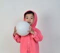 Little girl holding the ball.