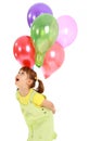 Little girl holding balloons