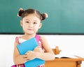 little girl holding book in classroom Royalty Free Stock Photo