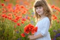 Little girl holding a bouquet poppies