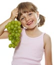 Little girl holding a bunch of green wine grapes Royalty Free Stock Photo