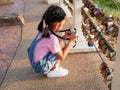 A little girl holding camera with taking a picture. Asian kid making photo travelling Royalty Free Stock Photo