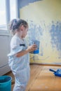 Little girl holding canister with paint at her room, making renovation. Royalty Free Stock Photo