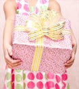 Little girl holding christmas gift box in the foreground Royalty Free Stock Photo