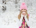 Little girl holding a cup of hot drink and smiling Royalty Free Stock Photo