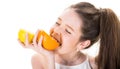 Little girl holding and eating lemons. Teenager holding citrus orange fruit. Beautiful little girl with oranges, lemons
