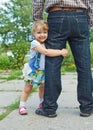 Little girl holding the feet of parents Royalty Free Stock Photo