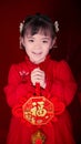 Little girl holding Fu character, Happy Chinese New Year