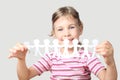 Little girl holding garland of paper little people Royalty Free Stock Photo