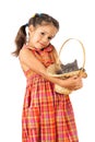 Little girl holding a gray kitten in basket