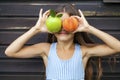 Little girl holding a green apple and a peach Royalty Free Stock Photo