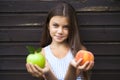 Little girl holding a green apple and a peach Royalty Free Stock Photo