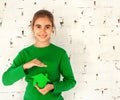 Little girl holding green house in hands Royalty Free Stock Photo