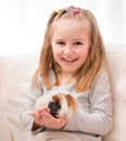 Little girl holding guinea pig on hands Royalty Free Stock Photo