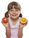 Little girl holding a half tomato and a half orang