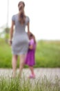 Little girl holding a hand of her mother. Family relations concept. Royalty Free Stock Photo