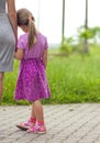 Little girl holding a hand of her mother. Family relations concept. Royalty Free Stock Photo