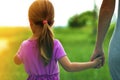 Little girl holding a hand of her mother. Family relations concept. Royalty Free Stock Photo