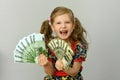 Little girl holding in hands a pack of dollars and Euro Royalty Free Stock Photo