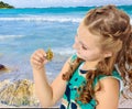 Little girl holding in hands a small turtle. Royalty Free Stock Photo