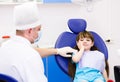 Little girl holding her cheek with a toothache at Royalty Free Stock Photo