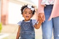 Little girl holding her mothers hand.