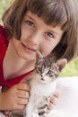 Little girl holding kitten