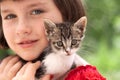 Little girl holding kitten