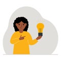 A little girl is holding a light bulb in his hand. Concept of idea, brainstorming, thinking, solution, eureka, bingo