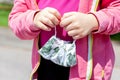 Little girl holding a medical protective face mask in hands, closeup. Small child holding taken off anti viral mask