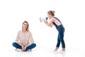 Little girl holding megaphone and screaming at pensive mother sitting