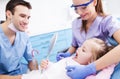 Little girl holding mirror at dentists Royalty Free Stock Photo