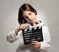 Little girl holding a movie clapper board