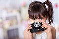 Little girl holding an old camera Royalty Free Stock Photo