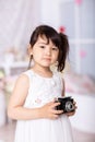 Little girl holding an old camera Royalty Free Stock Photo