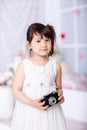 Little girl holding an old camera Royalty Free Stock Photo