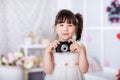 Little girl holding an old camera Royalty Free Stock Photo