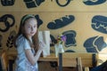 Little girl holding a paper bag with food in her hands Royalty Free Stock Photo