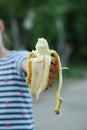 Little Girl Holding Peeled Banana Snack Healthy Food Eatting in the Park Educational Food Parenting