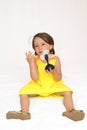 Little girl holding a plastic toy fan Royalty Free Stock Photo