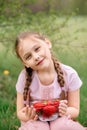 Little Girl Holding plate with Strawberries in nature. Gardening and agriculture concept. Vegan vegetarian. Vertical Royalty Free Stock Photo